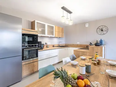 a kitchen with a table with a bowl of fruit on it at Apartment Vignola 2 by Interhome in Porto-Vecchio