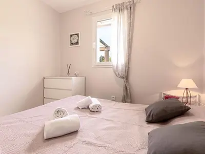 a white bedroom with a bed with towels on it at Holiday Home A Vigna by Interhome in Sotta