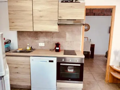 a kitchen with a stove and a sink at Appartement T2 Porto in Porto Ota