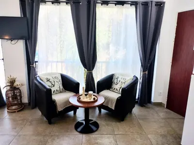 a living room with two chairs and a table at Appartement T2 Porto in Porto Ota