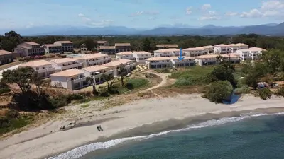 an aerial view of a resort on the beach at T3 vue mer direct plage clim N79 in Linguizzetta