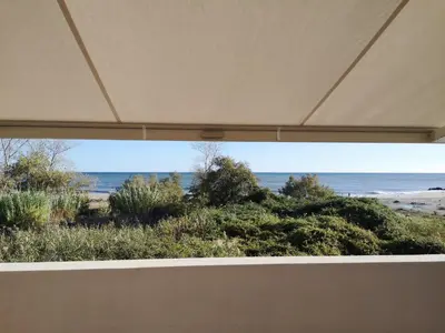 a view of the beach through a window at T3 vue mer direct plage clim N79 in Linguizzetta