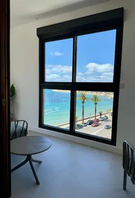 a room with a large window with a view of the beach at Hyper Centre, Front De Mer in Ajaccio