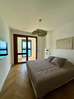 a bedroom with a large bed and a window at Hyper Centre, Front De Mer in Ajaccio
