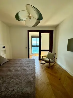 a bedroom with a bed and a ceiling fan and a chair at Hyper Centre, Front De Mer in Ajaccio