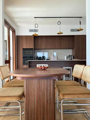 a kitchen with a wooden table and chairs at Hyper Centre, Front De Mer in Ajaccio