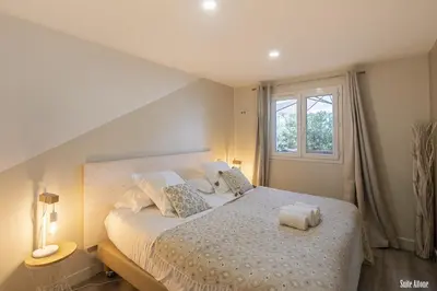 a bedroom with a large white bed with a window at Résidence CasaBianca Porticcio - Aïtone in Porticcio