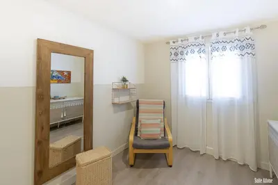 a mirror and a chair in a room at Résidence CasaBianca Porticcio - Aïtone in Porticcio