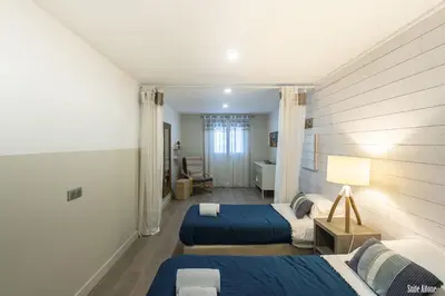 a hotel room with two beds and a bathroom at Résidence CasaBianca Porticcio - Aïtone in Porticcio
