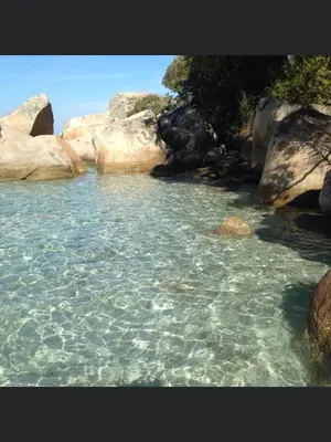 a large body of water with rocks and water at Appartement proche des plages in Porto-Vecchio
