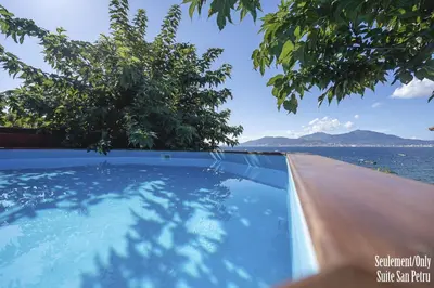 a swimming pool with a view of the water at Résidence CasaBianca Porticcio - San Petru in Porticcio
