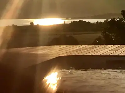 a view of the sunset from the roof of a house at Villa Pierre SANTONI in Porticcio