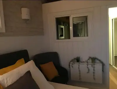 a living room with two chairs and a couch at Villa Pierre SANTONI in Porticcio