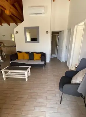 a living room with a couch and a coffee table at Villa Pierre SANTONI in Porticcio