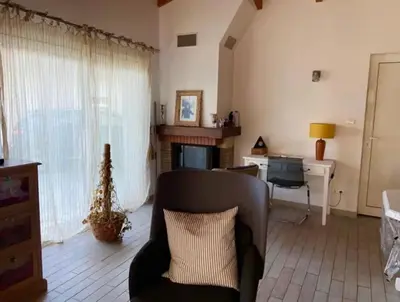 a living room with a chair and a desk at Villa Pierre SANTONI in Porticcio