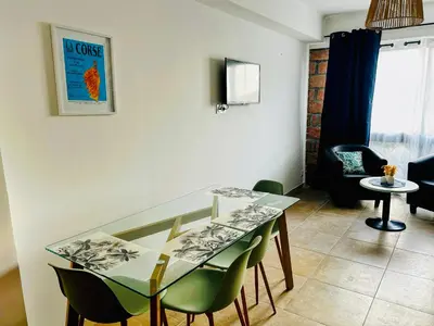 a table with a plate of food on a balcony at Entre montagne et mer in Porto Ota