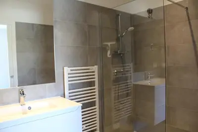 a bathroom with a shower and a sink and a mirror at Villa Arinella Villata Di Capicciola in Sainte-Lucie de Porto-Vecchio