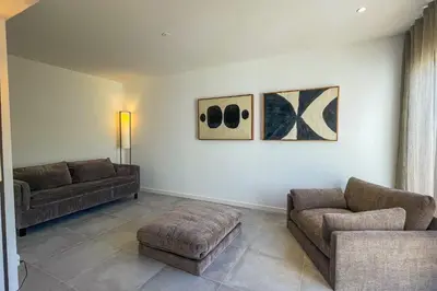 a living room with two couches and a couch at Villa Arinella Villata Di Capicciola in Sainte-Lucie de Porto-Vecchio