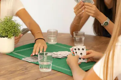 a group of people sitting at a table playing poker at Corsica Hostel Porto-Vecchio, partie dortoirs in Porto-Vecchio