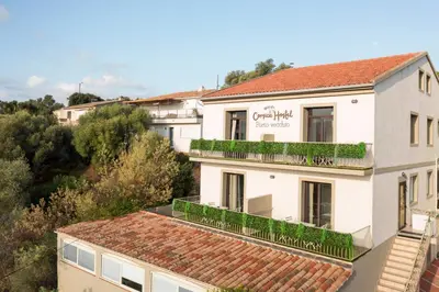 a view of a building with plants on the balconies at Corsica Hostel Porto-Vecchio, partie dortoirs in Porto-Vecchio