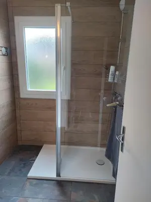 a shower in a bathroom with a window at Sartène Appartement 3 pièces vue mer avec jardin in Sartène