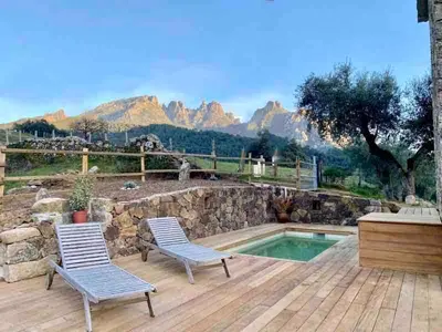 a patio with two chairs and a swimming pool at Particasgiu - Agritourisme in Vico