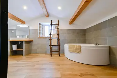a bathroom with a large tub and a sink at Particasgiu - Agritourisme in Vico