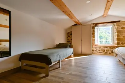 a bedroom with a bed in the corner of a room at Particasgiu - Agritourisme in Vico