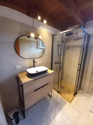 a bathroom with a sink and a shower with a mirror at A CASA DI PAULINA in Serra-di-Ferro