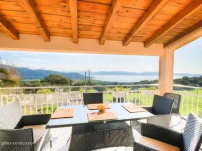 a patio with a table and chairs and a large window at A CASA DI PAULINA in Serra-di-Ferro