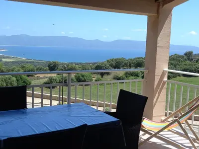 a blue table and chairs on a balcony with a view at A CASA DI PAULINA in Serra-di-Ferro
