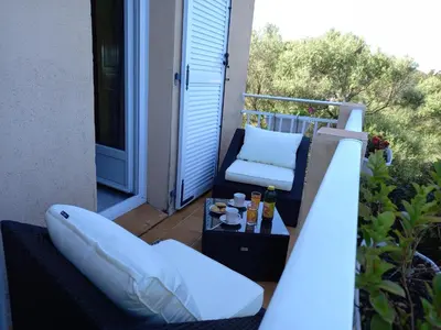a balcony with a couch and a chair on a porch at A CASA DI PAULINA in Serra-di-Ferro