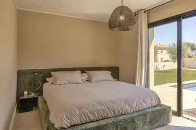 a bedroom with a bed and a large window at Villa Vignarella in Sorbo-Ocagnano