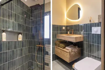 a bathroom with a sink and a shower with blue tiles at Villa Vignarella in Sorbo-Ocagnano