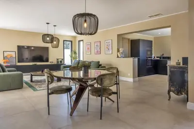 a dining room and living room with a table and chairs at Villa Vignarella in Sorbo-Ocagnano