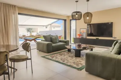 a living room with a couch and a tv at Villa Vignarella in Sorbo-Ocagnano