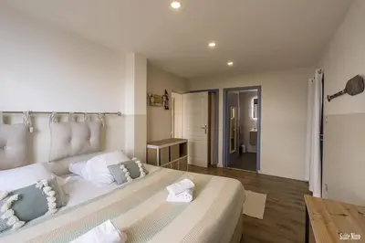 a bedroom with a large white bed with pillows at Résidence CasaBianca Porticcio - Nino in Grosseto-Prugna