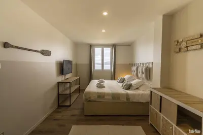 a bedroom with a bed and a television in it at Résidence CasaBianca Porticcio - Nino in Grosseto-Prugna