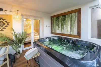 a large bath tub in a room with a window at Résidence CasaBianca Porticcio - Aliva in Porticcio