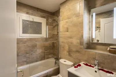 a bathroom with a tub and a toilet and a sink at Résidence CasaBianca Porticcio - Aliva in Porticcio