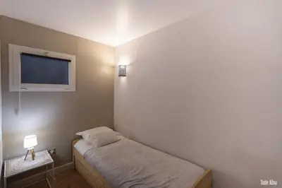 a small room with a bed and a flat screen tv at Résidence CasaBianca Porticcio - Aliva in Porticcio