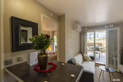 a living room with a vase with flowers on a table at Résidence CasaBianca Porticcio - Aliva in Porticcio