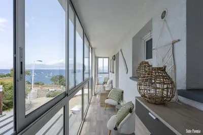 a room with a balcony with a view of the ocean at Résidence CasaBianca Porticcio - Paomia in Porticcio