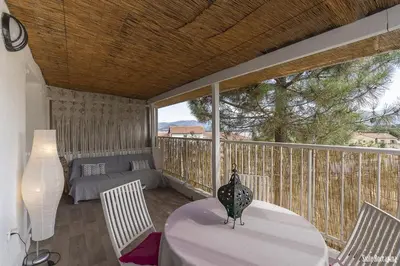 a balcony with a table and chairs and a couch at Résidence CasaBianca Porticcio - Roccapina in Porticcio