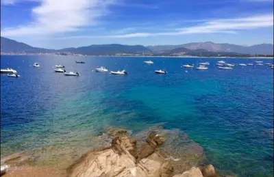 a group of boats in a large body of water at Résidence CasaBianca Porticcio - Roccapina in Porticcio