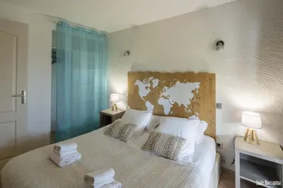 a bedroom with a bed with two towels on it at Résidence CasaBianca Porticcio - Roccapina in Porticcio