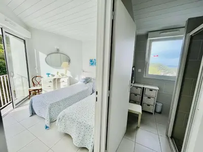 a bedroom with two beds and a window at Maison 4 pièces PIETROSELLA in Pietrosella