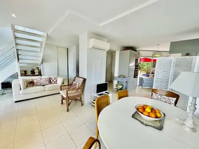 a living room with a table with a bowl of fruit on it at Maison 4 pièces PIETROSELLA in Pietrosella