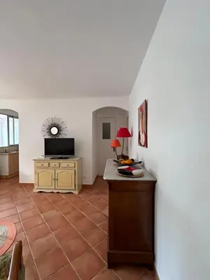 a living room with a table and a television at T3 Ajaccio rte des Sanguinaires in Ajaccio