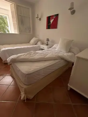 two twin beds in a room with a window at T3 Ajaccio rte des Sanguinaires in Ajaccio